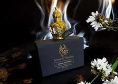 Black Leather Oud perfume oil by Jamal Al Muslim, elegantly displayed with floral elements and smoke background.