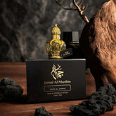 Oud Al Jamal Attar 12ml bottle and packaging on wooden surface, showcasing luxurious non-alcoholic Arabian fragrance.