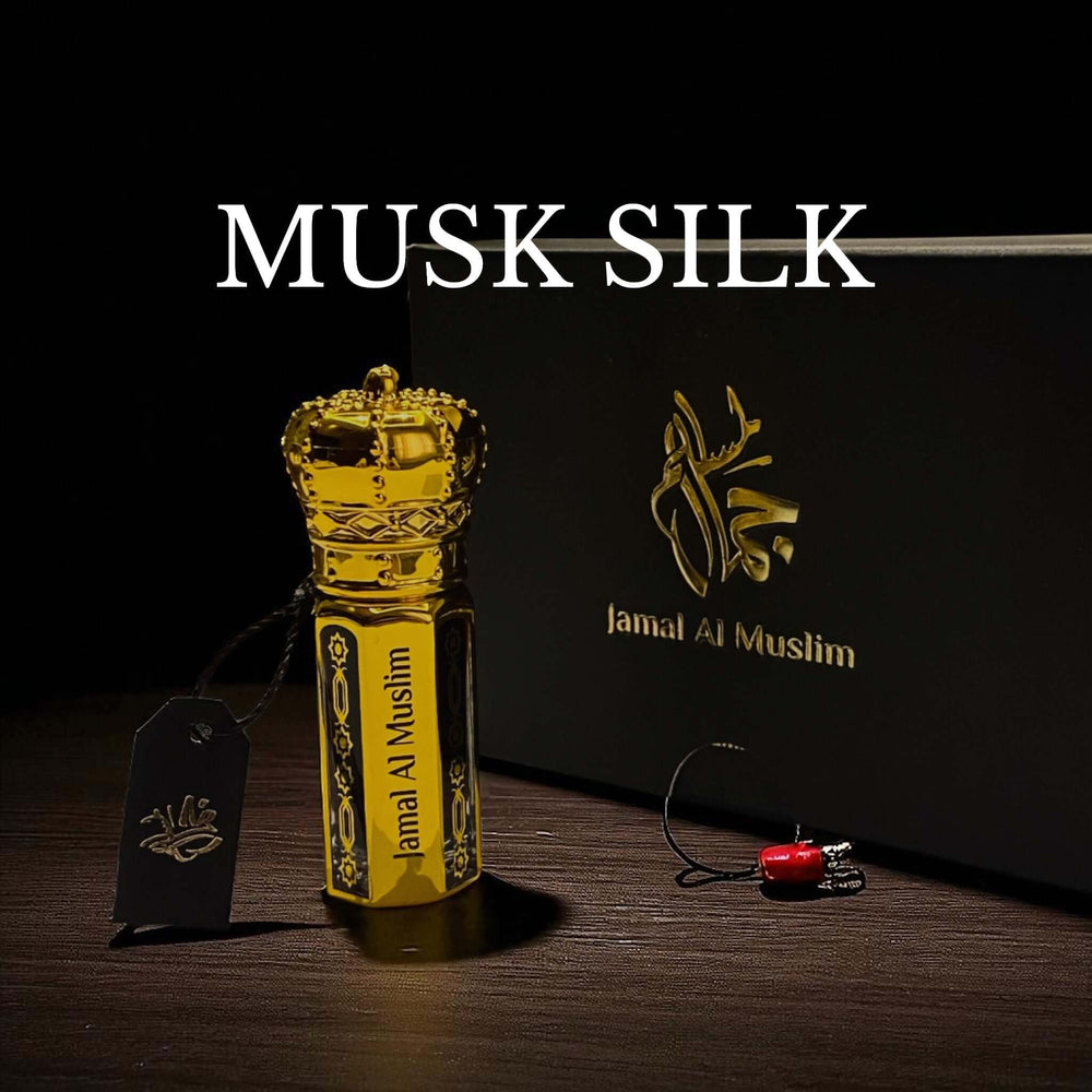 Musk Silk attar bottle in ornate gold packaging with crown design and Jamal Al Muslim logo.