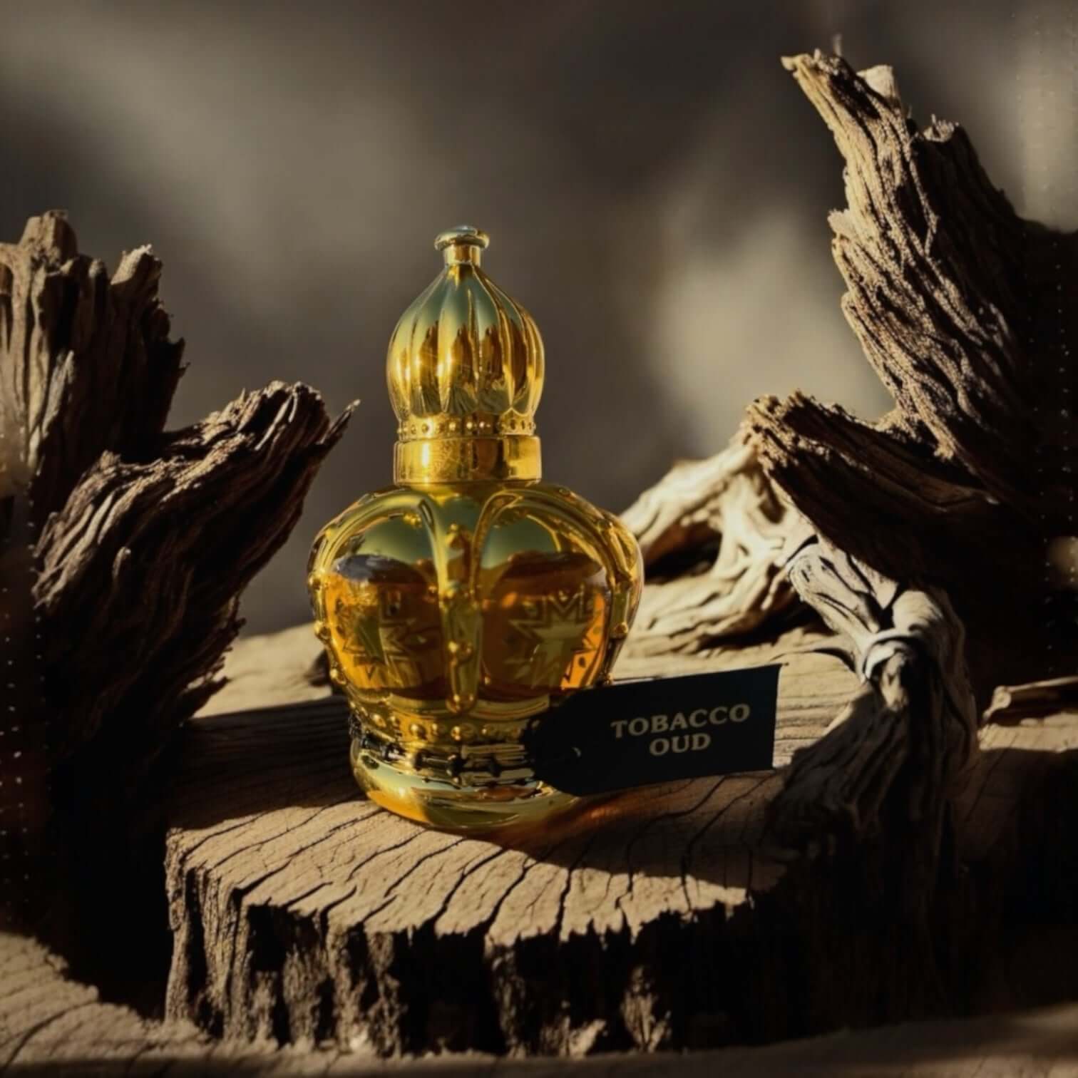 Tobacco Oud perfume bottle in ornate golden design, placed on a rustic wooden surface.