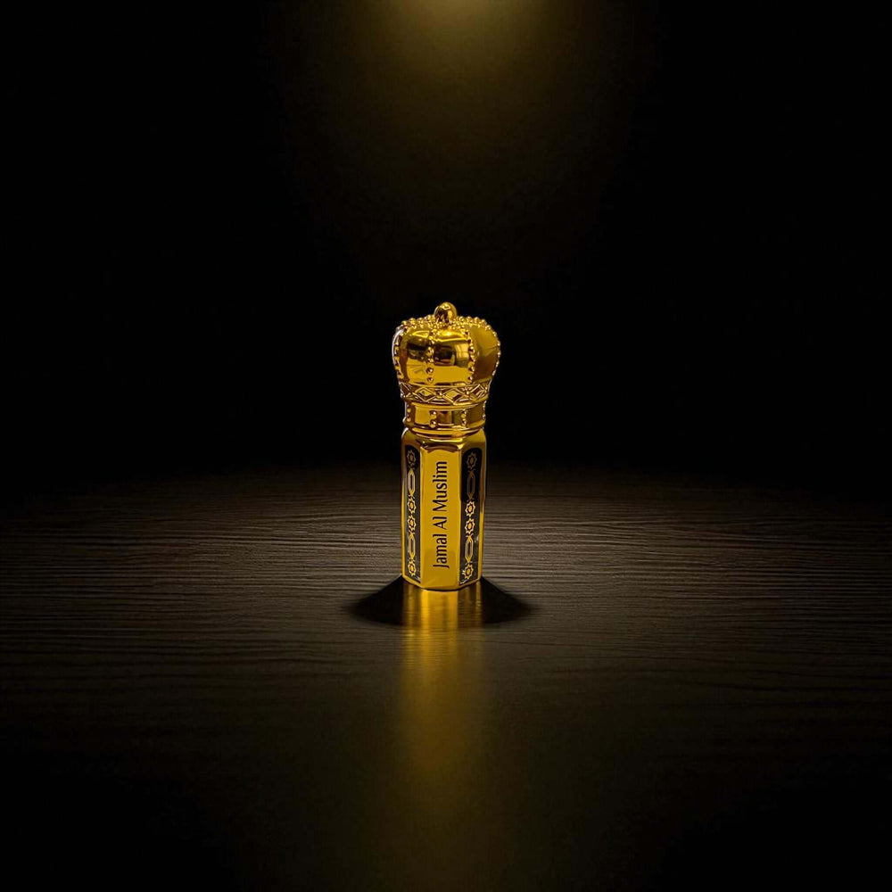 Oud Malaki organic Arabian Oud Oil in a luxurious gold bottle with crown design, showcasing elegance.